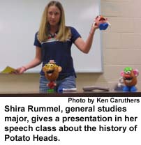 Shira Rummel, general studies major, gives a presentation in her speech class about the history of Potato Heads.