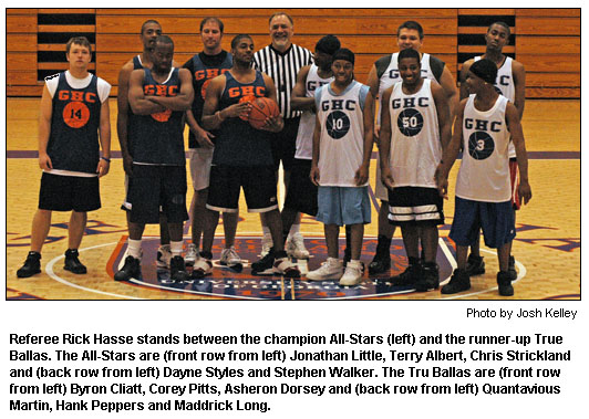 Referee Rick Hasse stands between the champion All-Stars (left) and the runner-up True Ballas. The All-Stars are (front row from left) Jonathan Little, Terry Albert, Chris Strickland and (back row from left) Dayne Styles and Stephen Walker. The Tru Ballas are (front row from left) Byron Cliatt, Corey Pitts, Asheron Dorsey and (back row from left) Quantavious Martin, Hank Peppers and Maddrick Long.
