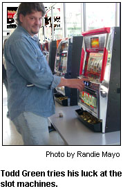 Todd Green tries his luck at the slot machines.