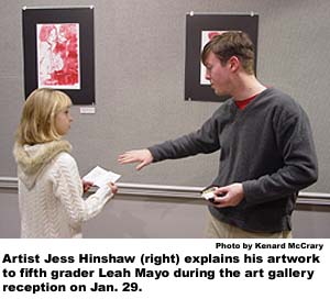 Artist Jess Hinshaw(right) explains his artwork to fifth grader Leah Mayo during the art gallery reception on Jan 29.