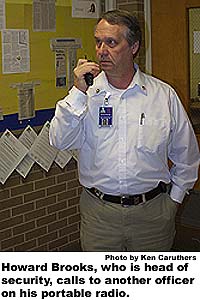 Howard Brooks, who is head of security, calls to another officer on his portable radio.
