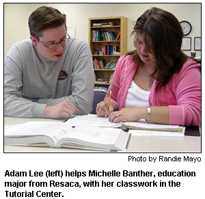 Adam Lee helps a fellow student with her classwork.