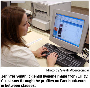 Jennifer Smith, a dental hygiene major from Ellijay, Ga., scans through the profiles on Facebook.com in between classes.