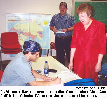 Dr. Margaret Davis answers a question from student Chris Cox (left) in her Calculus IV class as Jonathan Jarrel looks on.