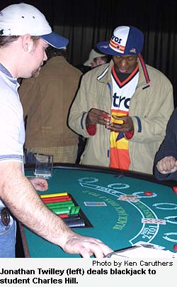 Jonathan Twilley (left) deals blackjack to student Charles Hill.
