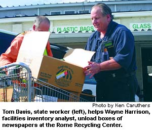 Tom Davis, state worker (left), helps Wayne Harrison, facilities inventory analyst, unload boxes of newspaper at the Rome Recycling Center.
