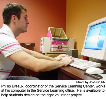 Phillip Breaux, coordinator of the Service Learning Center, works at his computer in the Service Learning office.  He is available to help students decide on the right volunteer project.