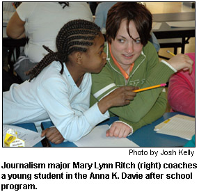 Journalism major Mary Lynn Ritch (right) coaches a young student in the Anna K. Davie after school program.