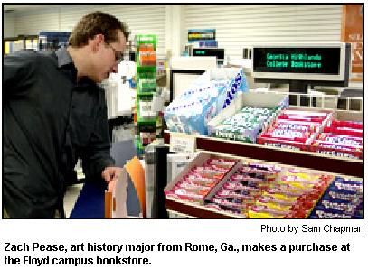 Zach Pease, art history major from Rome, Ga., makes a purchase at the Floyd campus bookstore.