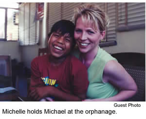 Michelle holds Michael at the orphanage
