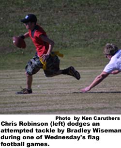 Chris Robinson (left) dodges an attempted tackle by Bradley Wiseman during one of Wednesday's flag football games.