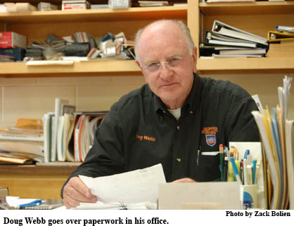 Doug Webb goves over paperwork in his office.