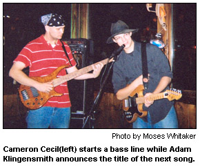 Cameron Cecil starts a bass line while Adam Klingensmith announces the title of the next song.