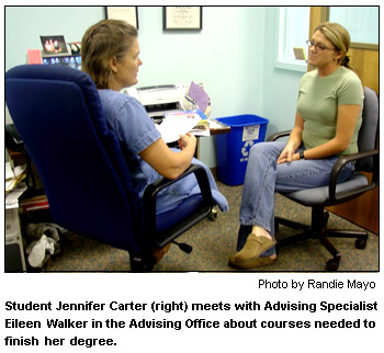 Student Jennifer Carter (right) meets with Advising Specialist Eileen Walker in the Advising Office about courses needed to finish her degree.