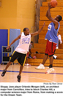 Sloppy Joes player Orlando Morgan (left), an architect
major from Carrollton, tries to block Charles Hill, a
computer science major from Rome, from making a score
for the Dream Team.