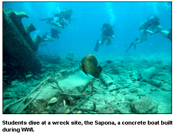 Students dive at a wreck site, the Sapona, a concrete boat built during WWI.