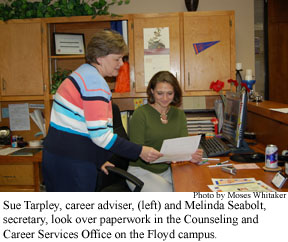 Sue Tarpley, career adviser, (left) and Melinda Seabolt, secretary, look over paperwork in the Counseling and Career Services Office on the Floyd campus. 