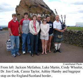 From left: Jackson Mcgehee, Luke Martin, Cindy Wheeler, Dr. Jim Cook, Cassie Taylor, Ashley Hamby and bagpiper stop on the England/Scotland border