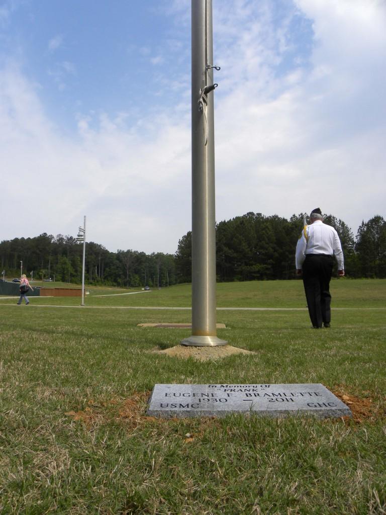 The plaque near the flagpole is dedicated to Bramlette's service to country and college.