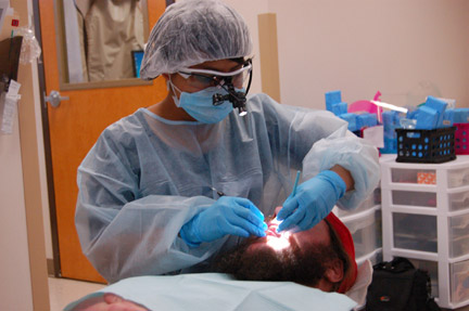 Student Cindy Palacios doing dental procedure on Jimmy Bowen. Photo taken by Andrew West.