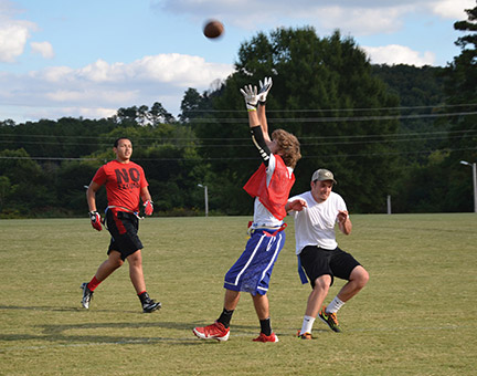 From left to right, students Cameron Johnson, Jack Harwell and Caleb Payne playing flag football. Photo by Pedro Zavala.