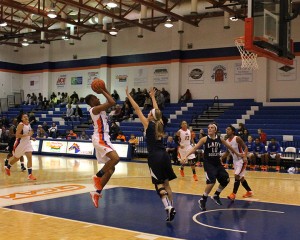 Aujana Dawkins, 24, takes a jump shot.