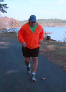 Bill Cox crosses the finish line within one minute of his estimated finish time during Turkey Day Walk event to win a $25 gift card to Honey Baked Ham. Photo by Pedro Zavala