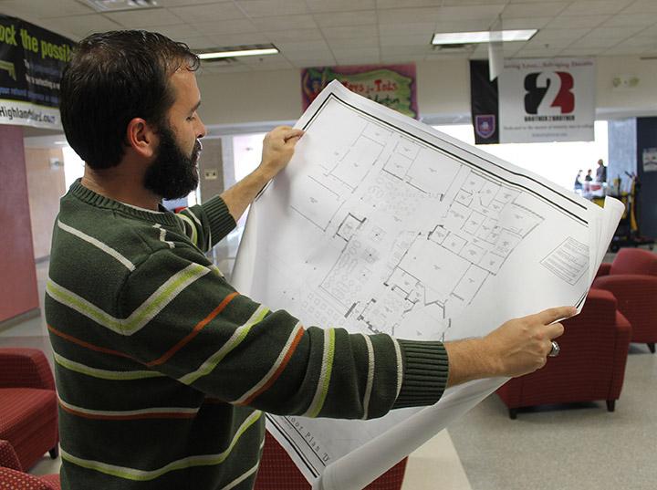 John Spranza looks at the blue prints for the student center remodel by Ryan Jones