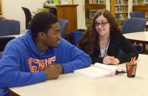 Donavan Harris (left) is tutored by Jennifer Hicks (right) in the Tutorial Center. Photo by Pedro Zavala