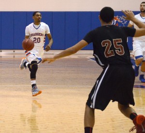 Demaurius Morgan, number 20, moves the ball down court in the last home game of the 2013-14 season. Photo by Karlee Helms.