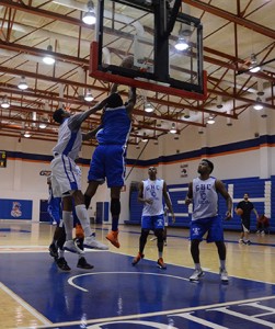 From left: Denzel Council attempts to block Donovan Harris as Terrence Thompson and Ty Toney await the rebound during a recent basketball workout. Karlee Helms.