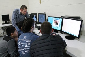 Mike Peterson, GHC information security specialist, helps the Rome High JROTC CyberPatriot program prepare for next season’s competition. Photo by Anna Douglass.