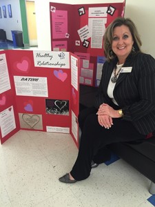 Angela Wheelus, director of Student Support Services, poses with her information on healthy relationships as a part of Day of Love on the Douglasville campus. Photo by Holly Chaney.
