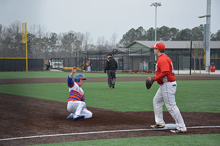 Blake Oxenreider slides safely into third base, March 1. Photo by Shelby Hogland.