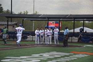 Chargers welcome Zach McCrum at home plate after his grand slam on April 7. Photo by Shelby Hogland.