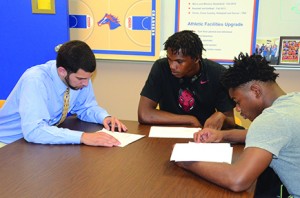 (From left) Matt Williams goes over information with prospective recruits Deontae Woodbridge and Shakari Jones, both from Arkansas. Photo by Karlee Helms.