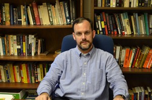 Bronson Long sits at his desk while he discusses his new book, "No Easy Occupation: French Control of the German Saar, 1944 - 1957." Photo by Taylor Barton