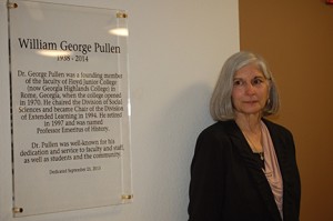 George Pullen's wife, Ann Pullen, stands next to plaque honoring her late husband.