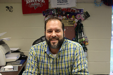 Spranza smiles as hes surrounded by his work, planning the next student activity for GHC. Photo by Lydia Chandler