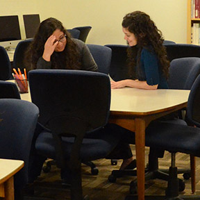 A GHC tutor helps a student understand a specific concept. File photo.  