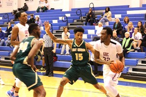 Keymont Jenkins attempts to keep the ball away from the opposing team, the Bobcats. Photo by Daniel Smith