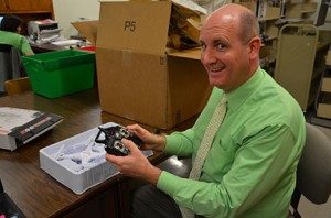 Elijah Scott, dean of libraries, explains how to fly the drone, which is equipped with an HD camera. Photo by Taylor Barton