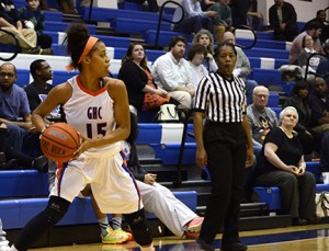 Auriana Broughton throws the ball into play, with a watchful eye from the ref. Photo by Taylor Barton