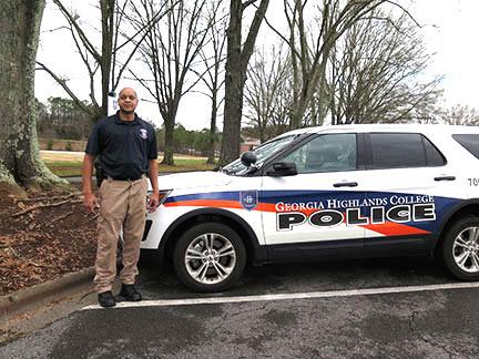 GHC Police Chief David Horace stands beside the police vehicle with the new logo designed by pre-nursing student Kendra Dee Robinson. Photo by Lydia Chandler