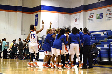 The Lady Chargers huddle up during a time out. Photo by Taylor Barton