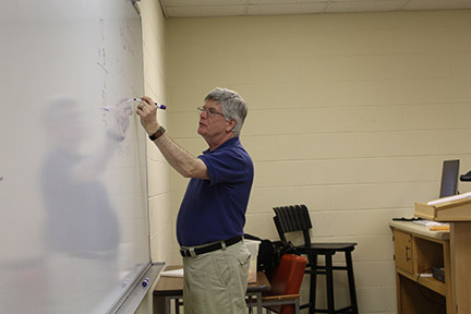 Johnny Duke writes a math formula in front of a Floyd campus class. Photo by Lydia Chandler