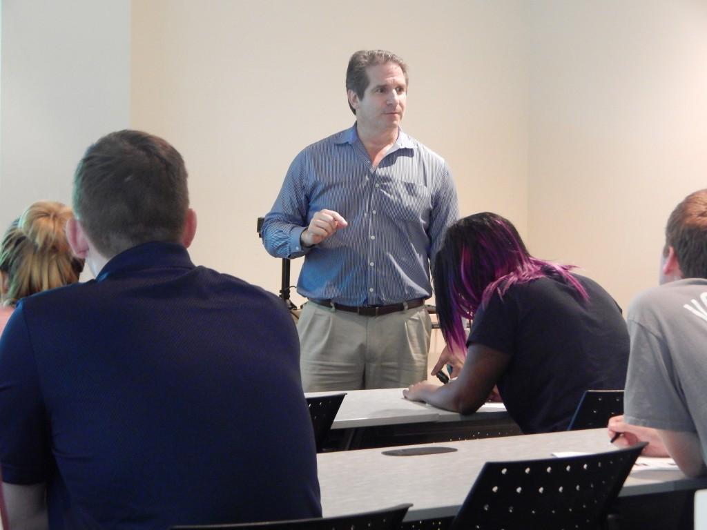 Students takes notes at a UGA  small business workshop at Marietta. 