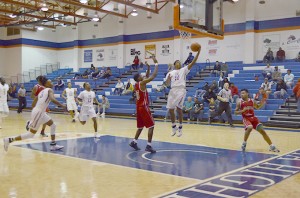 Antonio Wade dunks ball through the hoop during a game earlier this season. Photo by Kacey Neese