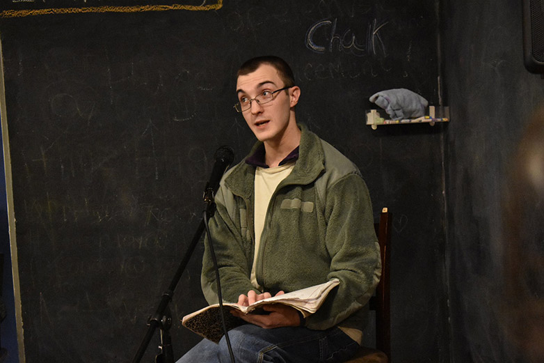 Connor Henderson, a Georgia Highlands College alumnus, reads his work during Poetry Night. 
Photo by Mary-Kate Billings