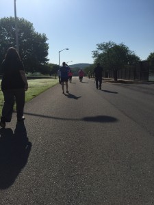 The participants of the FCA Prayer Walk head down next to the gym and tennis courts at the Floyd campus to Paris Lake. Photo by Joshua Mabry 